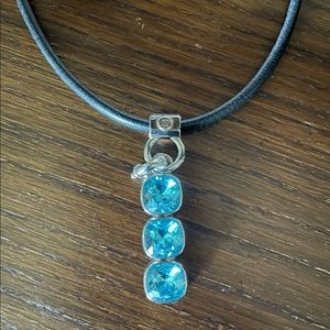 Black leather cord necklace with silver and light blue jewel removable pendant.